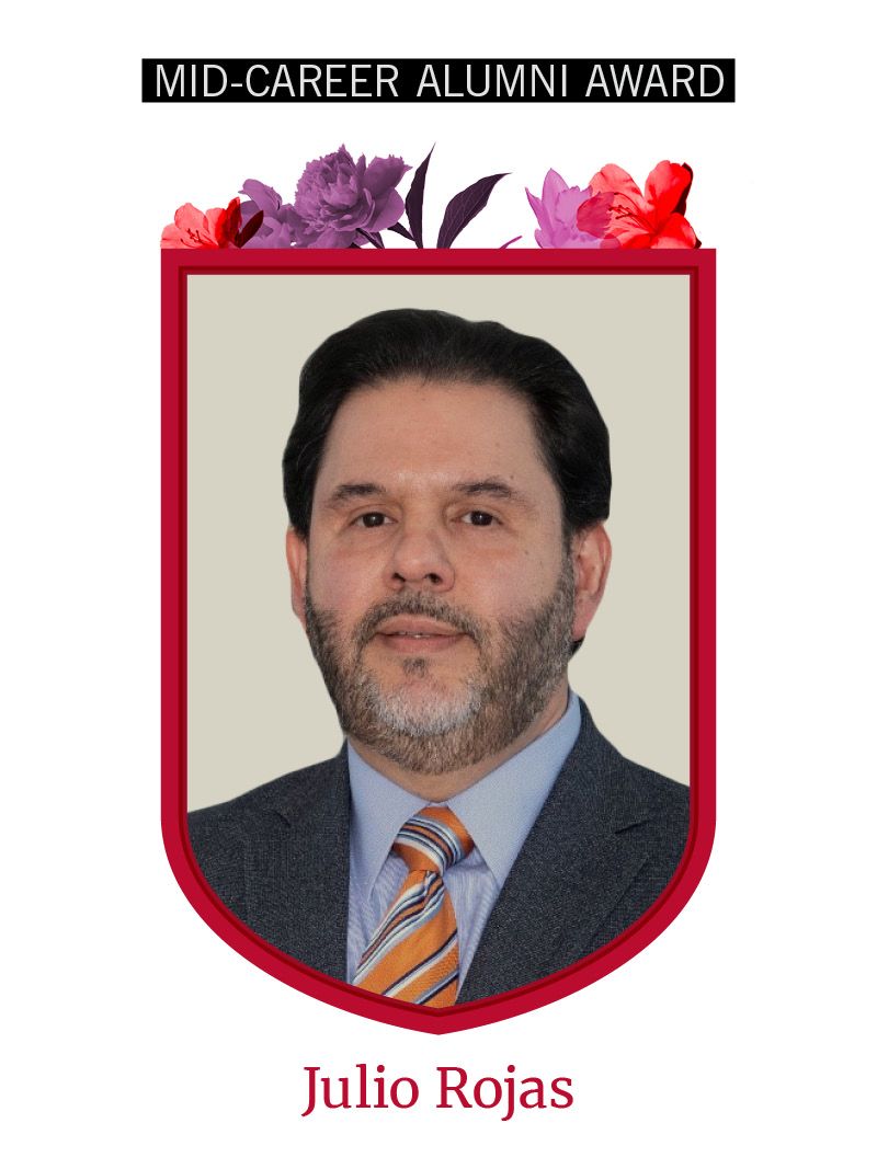 Photo of Julio Rojas framed by red shield shape and flowers. Text at the top reads "Mid-Career Alumni Award"