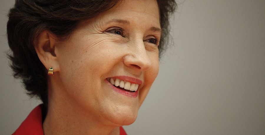 A close-up portrait of Inez Tenenbaum, smiling as she looks away from the camera
